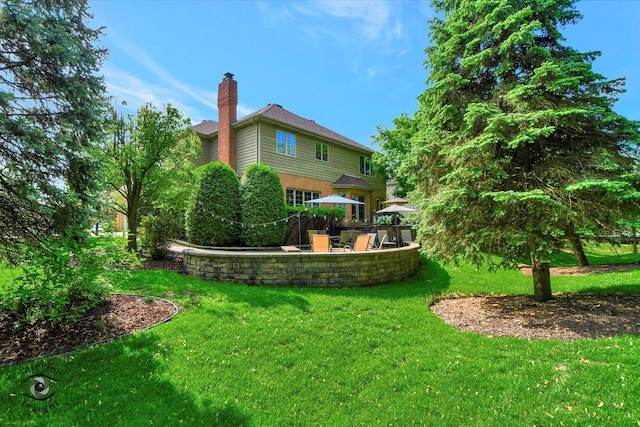 21048 Tall Grass Dr, Mokena, IL 60448 - rear view of house with a chimney, a patio area, and a lawn