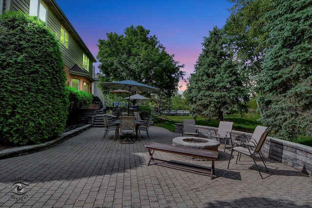 21048 Tall Grass Dr, Mokena, IL 60448 - patio terrace at dusk featuring a patio area and a fire pit