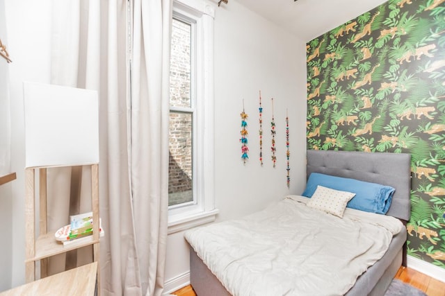 4805 S Langley Ave, Chicago, IL 60615 - bedroom featuring wallpapered walls, wood finished floors, and baseboards