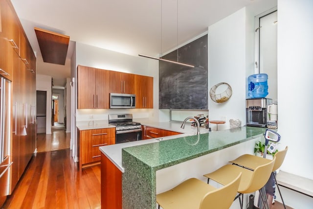 4805 S Langley Ave, Chicago, IL 60615 - kitchen with appliances with stainless steel finishes, brown cabinets, modern cabinets, and dark wood-style floors