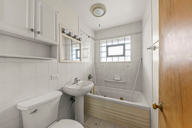 4537 Fishermans Ter, Lyons, IL 60534 - full bathroom with a combined bath / shower with jetted tub, tile walls, and tile patterned floors