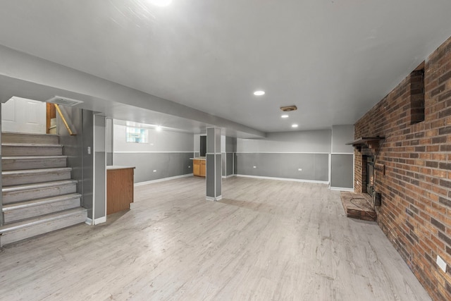4537 Fishermans Ter, Lyons, IL 60534 - basement with light wood-style flooring, brick wall, stairway, and a brick fireplace