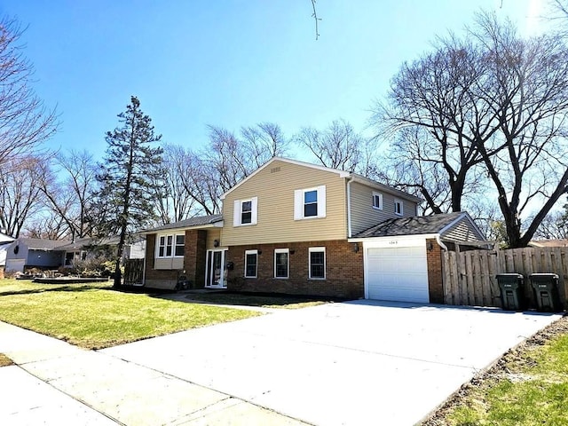 1343 E Anderson Dr, Palatine, IL 60074 - split level home featuring brick siding, an attached garage, and driveway