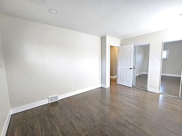 1343 E Anderson Dr, Palatine, IL 60074 - unfurnished bedroom with baseboards, wood finished floors, and multiple closets