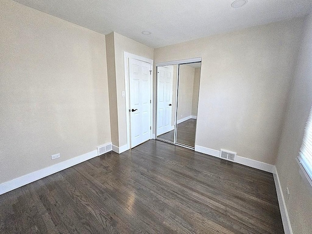 1343 E Anderson Dr, Palatine, IL 60074 - unfurnished bedroom featuring dark wood-style floors, baseboards, and a closet