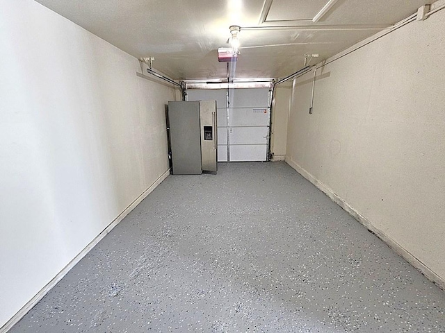 1343 E Anderson Dr, Palatine, IL 60074 - garage featuring stainless steel fridge with ice dispenser, a garage door opener, and baseboards