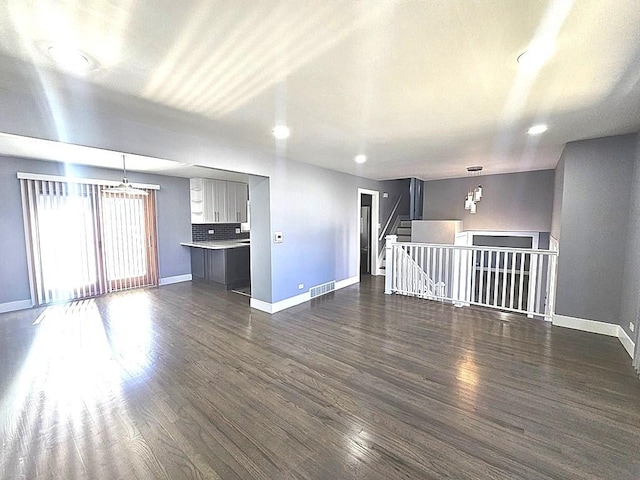 1343 E Anderson Dr, Palatine, IL 60074 - unfurnished living room with baseboards, dark wood-style floors, recessed lighting, and a chandelier