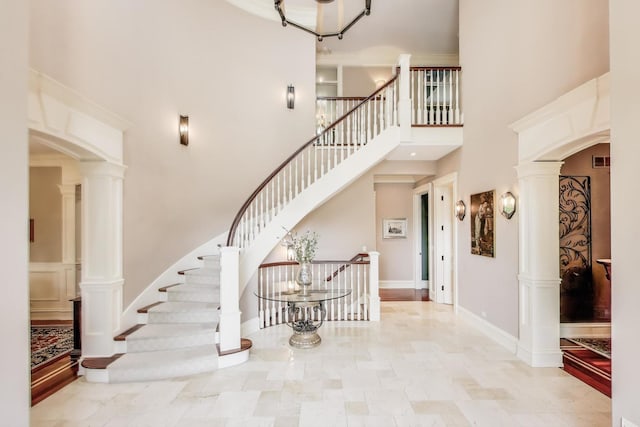 724 Becker Rd, Glenview, IL 60025 - entryway with a high ceiling, decorative columns, stairs, and arched walkways