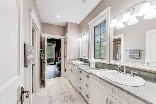 724 Becker Rd, Glenview, IL 60025 - bathroom with healthy amount of natural light, double vanity, tile patterned flooring, and a chandelier
