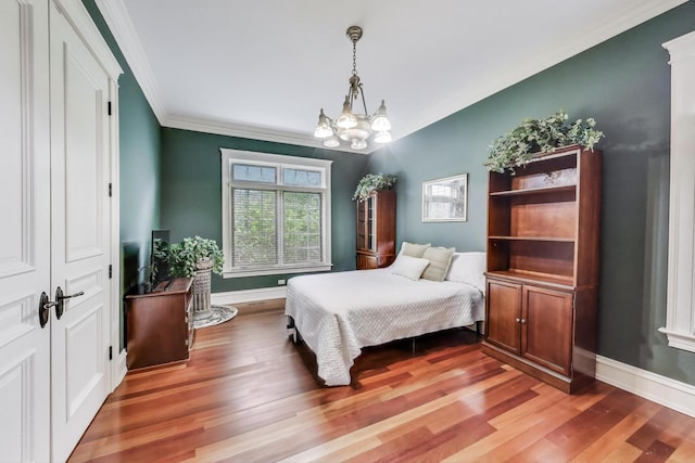724 Becker Rd, Glenview, IL 60025 - bedroom featuring light wood-type flooring, crown molding, baseboards, and a chandelier