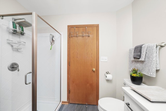 6235 S Knox Ave Unit K, Chicago, IL 60629 - full bathroom featuring a shower stall, toilet, and wood finished floors