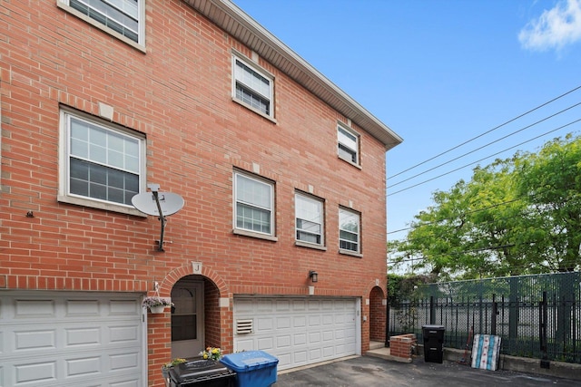 6235 S Knox Ave Unit K, Chicago, IL 60629 - view of home's exterior with an attached garage, brick siding, and asphalt driveway