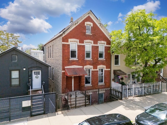 2227 W 21st St, Chicago, IL 60608 - view of front of property featuring brick siding, a fenced front yard, and a gate