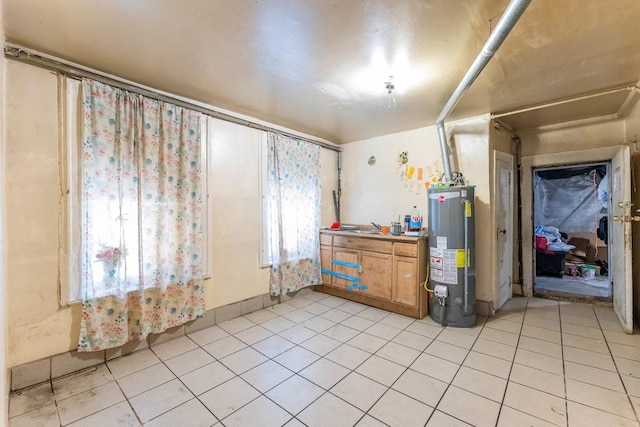 2227 W 21st St, Chicago, IL 60608 - empty room with water heater and light tile patterned floors