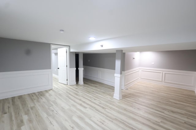 10817 S Eberhart Ave, Chicago, IL 60628 - unfurnished room featuring wainscoting, light wood-type flooring, and a decorative wall