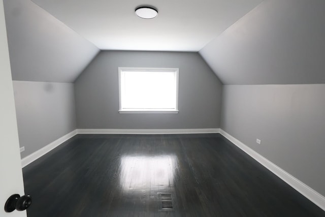 10817 S Eberhart Ave, Chicago, IL 60628 - additional living space with baseboards, dark wood finished floors, and lofted ceiling