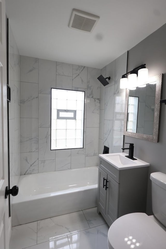 10817 S Eberhart Ave, Chicago, IL 60628 - bathroom with toilet, vanity, marble look tiles, and bathtub / shower combination