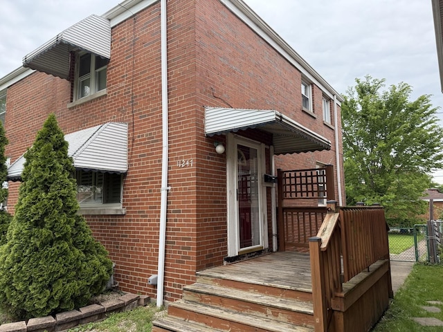 11247 S S Ave L, Chicago, IL 60617 - view of front of house with brick siding, a deck, and a gate