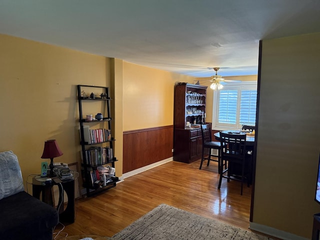 11247 S S Ave L, Chicago, IL 60617 - dining room featuring wood finished floors, ceiling fan, wainscoting, and wood walls