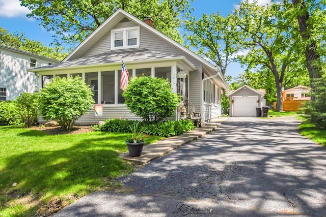 3019 Crescent Ave, Mchenry, IL 60050 - bungalow-style home featuring an outbuilding, a chimney, driveway, a detached garage, and a front lawn