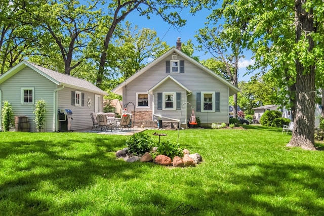 3019 Crescent Ave, Mchenry, IL 60050 - rear view of house with a lawn, a patio area, and a chimney