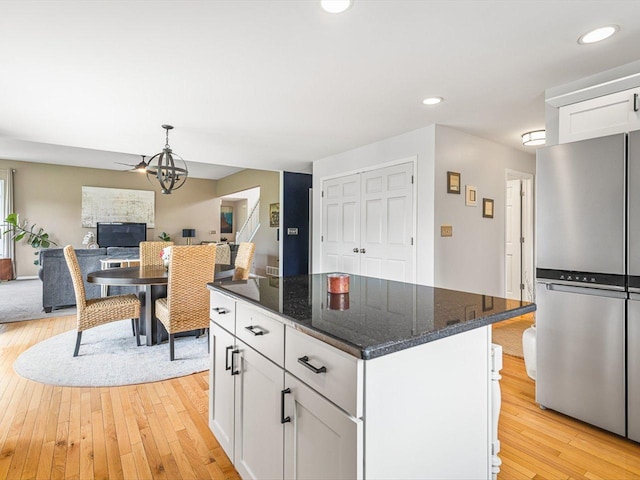 11546 Ridgecrest Dr, Roscoe, IL 61073 - kitchen featuring freestanding refrigerator, light wood-style flooring, white cabinets, a center island, and recessed lighting