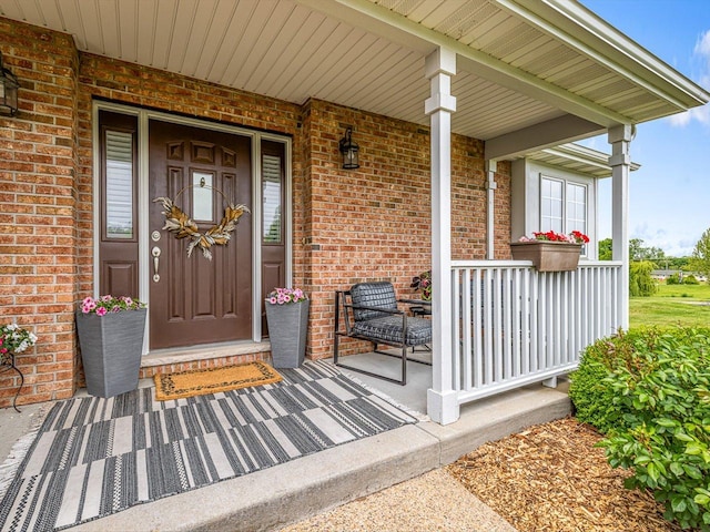 11546 Ridgecrest Dr, Roscoe, IL 61073 - view of exterior entry with a porch and brick siding