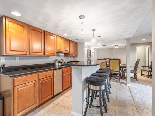 11546 Ridgecrest Dr, Roscoe, IL 61073 - kitchen with dishwasher, a kitchen bar, light tile patterned flooring, pendant lighting, and recessed lighting