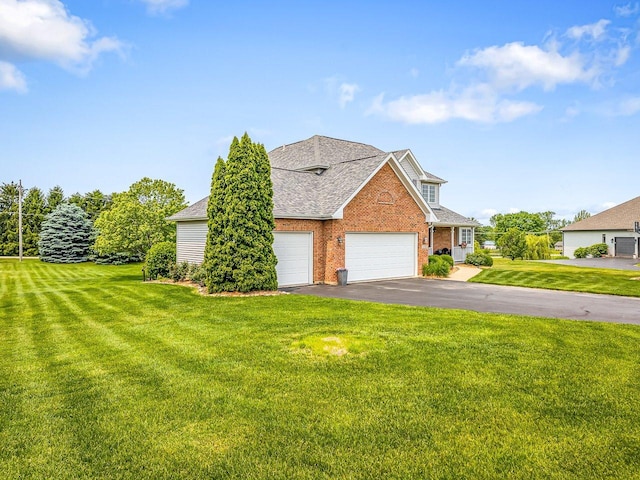 11546 Ridgecrest Dr, Roscoe, IL 61073 - view of front of property with a garage, a front lawn, brick siding, driveway, and roof with shingles