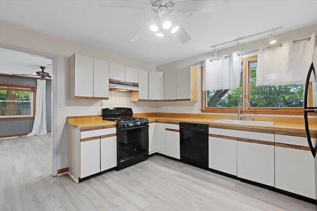 9 Craig Ter, Lake Zurich, IL 60047 - kitchen with black appliances, range hood, a ceiling fan, and light wood-style flooring