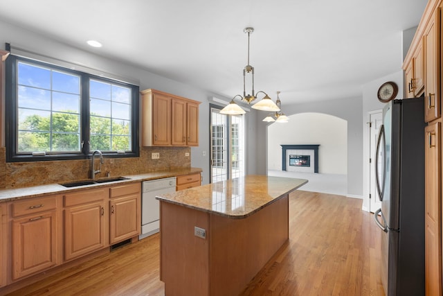 7N001 Ridge Line Rd, Saint Charles, IL 60175 - kitchen featuring freestanding refrigerator, white dishwasher, a kitchen island, decorative backsplash, and light stone countertops