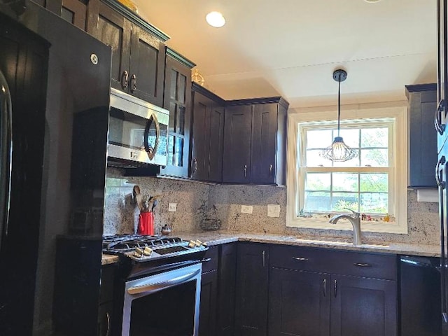 213 W Park Ave, Wheaton, IL 60189 - kitchen featuring appliances with stainless steel finishes, a sink, backsplash, and light stone countertops
