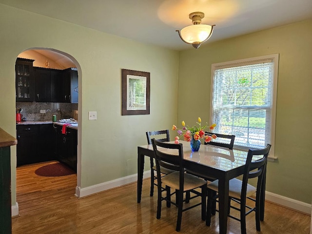 213 W Park Ave, Wheaton, IL 60189 - dining space with arched walkways, wood finished floors, and baseboards