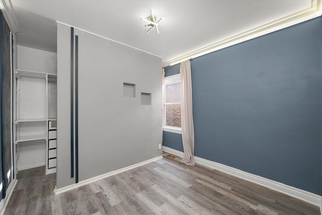 5151 W Fletcher St, Chicago, IL 60641 - unfurnished bedroom with wood finished floors, a closet, and baseboards