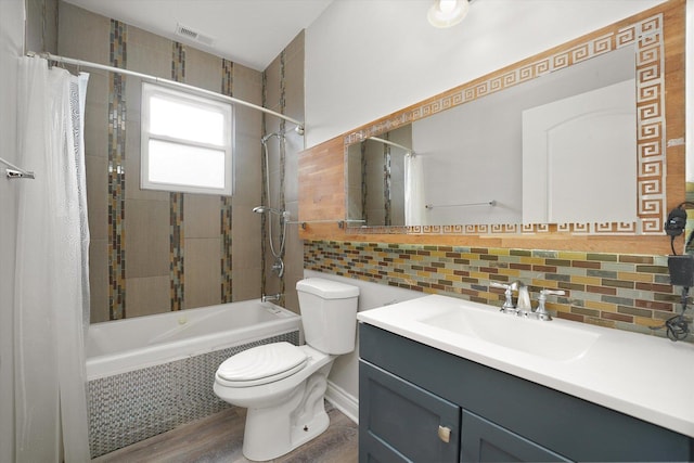 5151 W Fletcher St, Chicago, IL 60641 - full bathroom featuring tiled shower / bath combo, tasteful backsplash, toilet, vanity, and wood finished floors