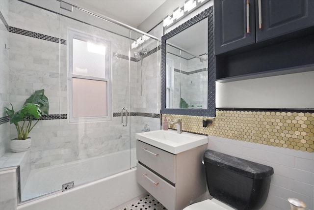 5151 W Fletcher St, Chicago, IL 60641 - full bath featuring tile walls, vanity, combined bath / shower with glass door, toilet, and decorative backsplash