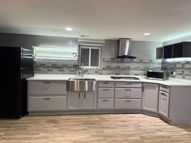 5151 W Fletcher St, Chicago, IL 60641 - kitchen with wall chimney range hood, stainless steel appliances, gray cabinets, a sink, and recessed lighting