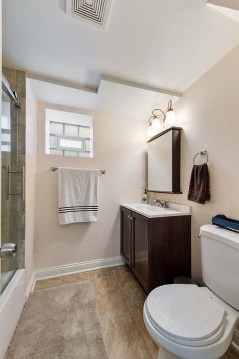 5151 W Fletcher St, Chicago, IL 60641 - full bathroom with vanity, toilet, tile patterned flooring, and baseboards
