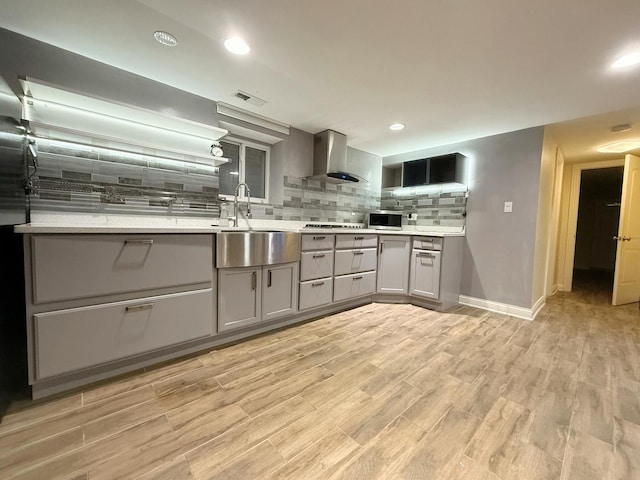 5151 W Fletcher St, Chicago, IL 60641 - kitchen with gray cabinets, wall chimney exhaust hood, a sink, backsplash, and stainless steel microwave