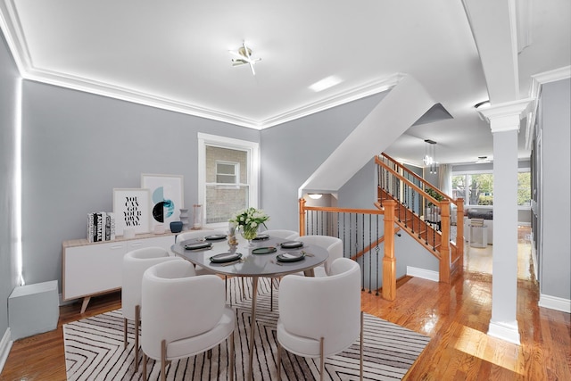 5151 W Fletcher St, Chicago, IL 60641 - dining space featuring ornate columns, light wood finished floors, baseboards, stairway, and crown molding
