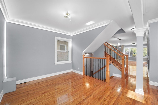 5151 W Fletcher St, Chicago, IL 60641 - unfurnished room featuring ornate columns, wood finished floors, baseboards, and crown molding