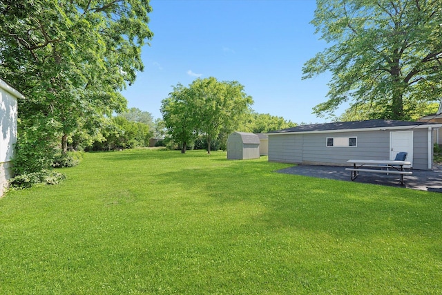 345 W Joe Orr Rd, Chicago Heights, IL 60411 - view of green lawn featuring a storage unit and a patio