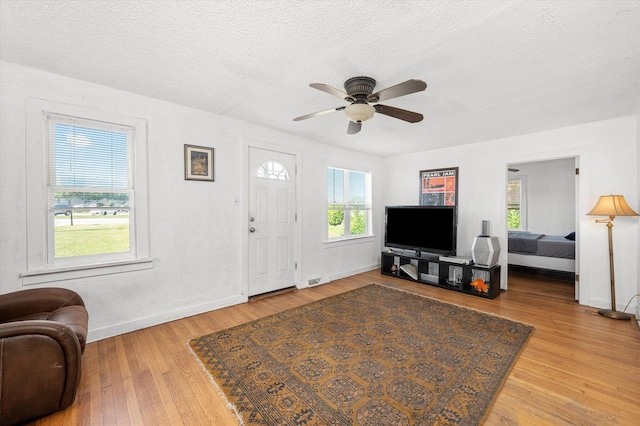 345 W Joe Orr Rd, Chicago Heights, IL 60411 - living area featuring wood finished floors, ceiling fan, and a textured ceiling