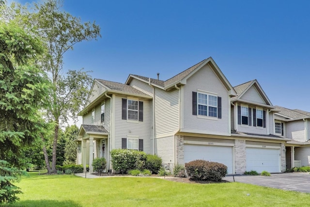 2253 Sunrise Cir, Aurora, IL 60503 - townhome / multi-family property with a garage, driveway, and a front lawn