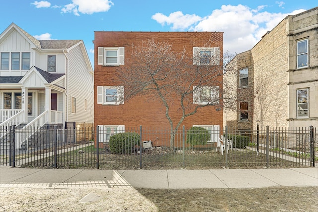 4730 N Hermitage Ave Unit 2F, Chicago, IL 60640 - view of front of house with brick siding and a fenced front yard