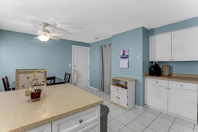 4730 N Hermitage Ave Unit 2F, Chicago, IL 60640 - kitchen featuring a ceiling fan, white cabinets, light tile patterned floors, baseboards, and light stone counters