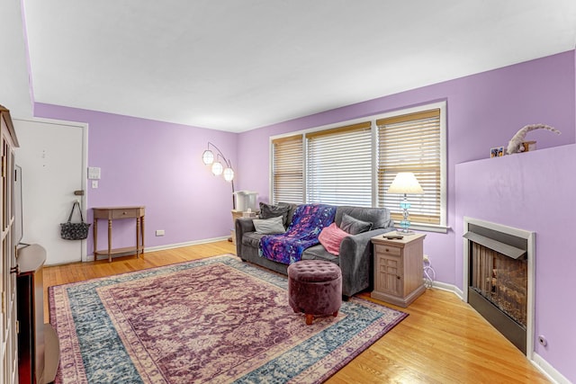 4730 N Hermitage Ave Unit 2F, Chicago, IL 60640 - living area with a fireplace, light wood-style floors, and baseboards