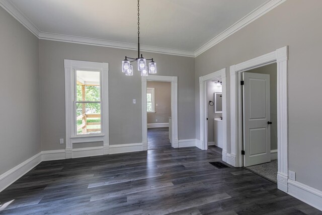 324 W Sumner St, Streator, IL 61364 - unfurnished dining area with a chandelier, crown molding, dark wood-style flooring, and baseboards