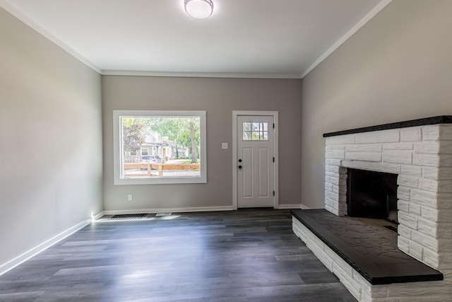 324 W Sumner St, Streator, IL 61364 - foyer with crown molding, a stone fireplace, wood finished floors, and baseboards