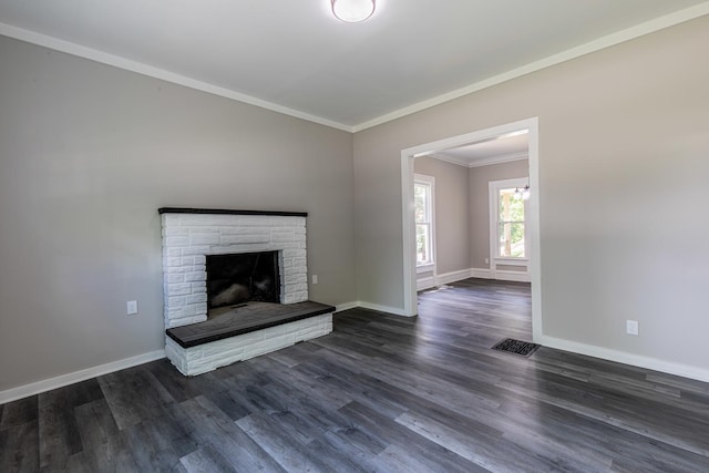 324 W Sumner St, Streator, IL 61364 - unfurnished living room with ornamental molding, baseboards, dark wood-style flooring, and a fireplace with raised hearth